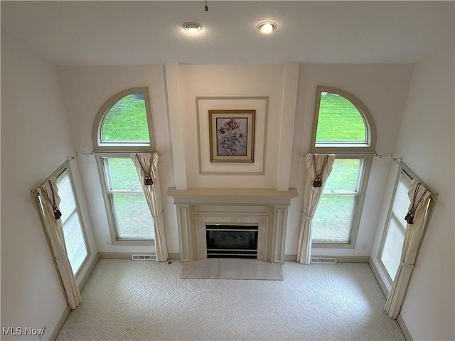 592 Charles Pl, Highland Heights, OH 44143 - unfurnished living room with baseboards, light colored carpet, and a fireplace with flush hearth