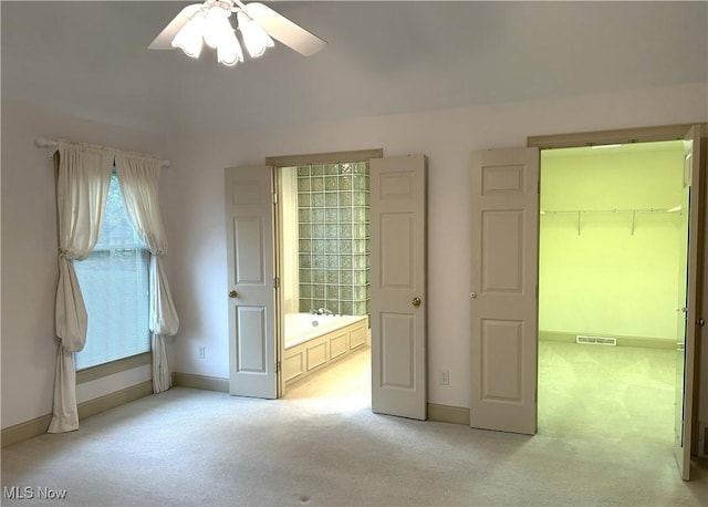 592 Charles Pl, Highland Heights, OH 44143 - unfurnished bedroom with light colored carpet, baseboards, a walk in closet, and ceiling fan