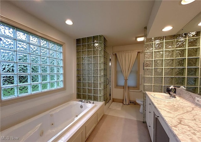 592 Charles Pl, Highland Heights, OH 44143 - full bathroom featuring a tub with jets, a tile shower, toilet, vanity, and recessed lighting