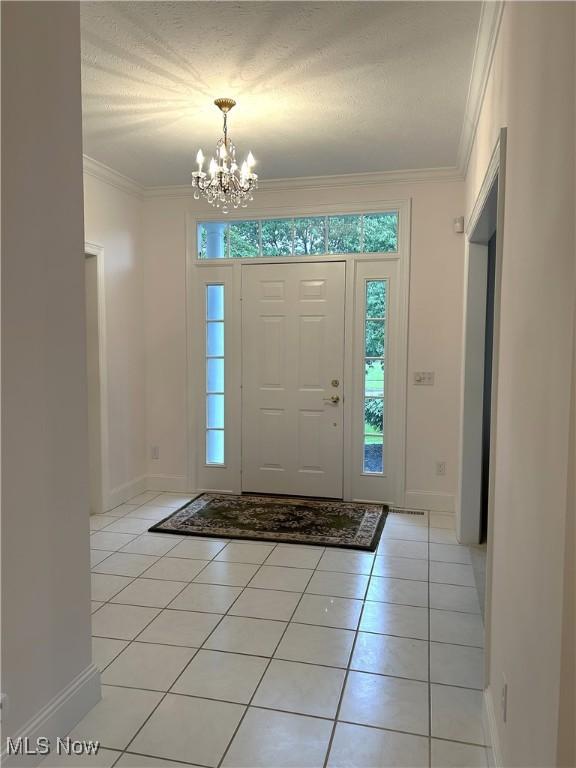 592 Charles Pl, Highland Heights, OH 44143 - entryway featuring a chandelier, light tile patterned floors, crown molding, and baseboards
