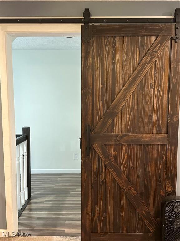 408 W Paradise St, Orrville, OH 44667 - detailed view of a barn door, baseboards, and wood finished floors
