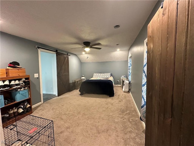 408 W Paradise St, Orrville, OH 44667 - bedroom with a barn door, carpet floors, baseboards, ceiling fan, and a textured ceiling