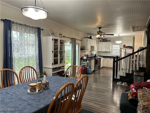408 W Paradise St, Orrville, OH 44667 - dining area with ornamental molding, a ceiling fan, stairway, and dark wood-style flooring