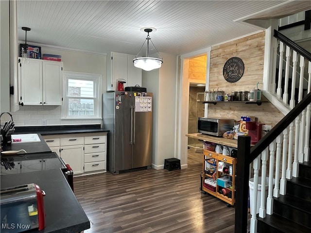 408 W Paradise St, Orrville, OH 44667 - kitchen featuring appliances with stainless steel finishes, a sink, dark countertops, white cabinets, and decorative light fixtures