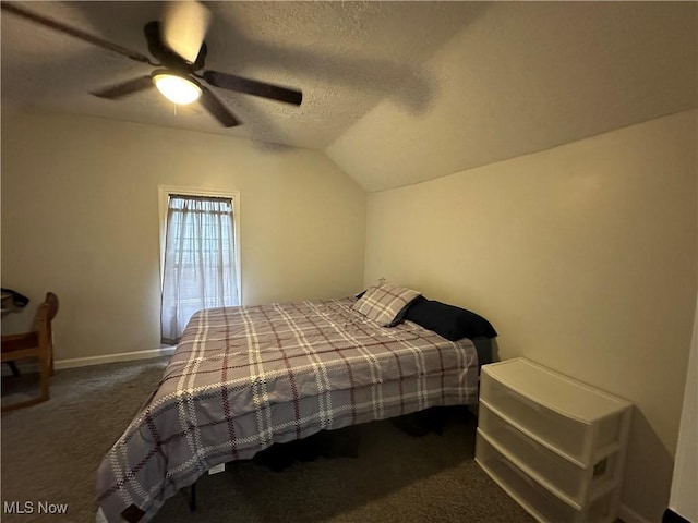 408 W Paradise St, Orrville, OH 44667 - bedroom with dark carpet, vaulted ceiling, a textured ceiling, a ceiling fan, and baseboards