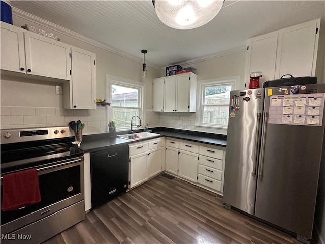 408 W Paradise St, Orrville, OH 44667 - kitchen with stainless steel appliances, ornamental molding, a sink, dark countertops, and white cabinets