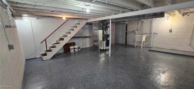 809 4th St, Brilliant, OH 43913 - unfinished basement with stairs, heating unit, and a sink