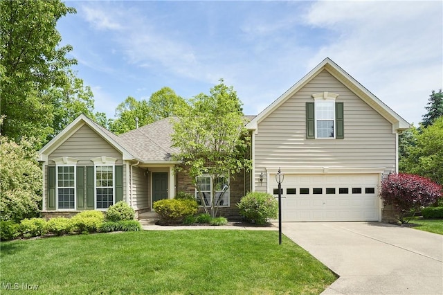 3563 Saint Andrews Ln, Richfield, OH 44286 - traditional-style home featuring a garage, concrete driveway, a front lawn, stone siding, and roof with shingles