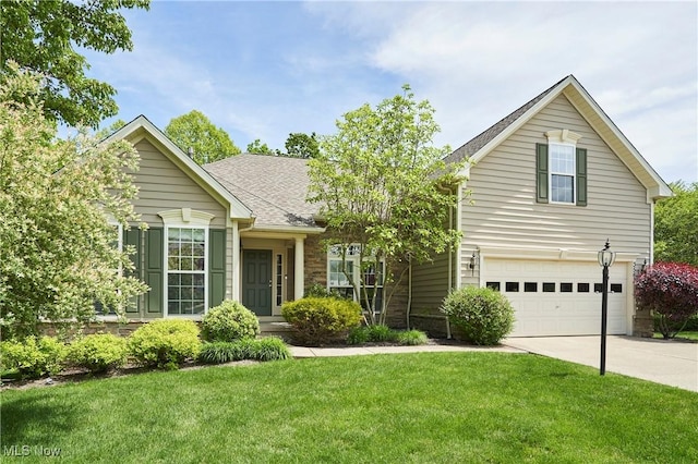 3563 Saint Andrews Ln, Richfield, OH 44286 - view of front of home with driveway, an attached garage, a front lawn, and a shingled roof