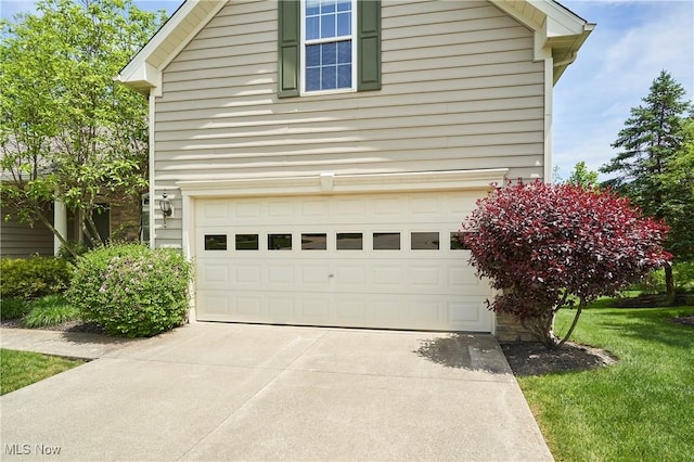 3563 Saint Andrews Ln, Richfield, OH 44286 - view of property exterior with a garage, driveway, and a lawn