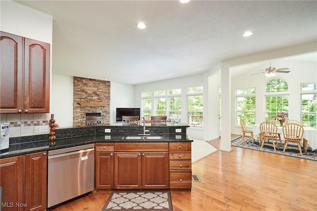 3563 Saint Andrews Ln, Richfield, OH 44286 - kitchen featuring dishwasher, a sink, open floor plan, a peninsula, and light wood finished floors