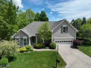 3563 Saint Andrews Ln, Richfield, OH 44286 - traditional-style home with concrete driveway, a garage, and a front lawn