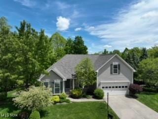 3563 Saint Andrews Ln, Richfield, OH 44286 - view of front of property featuring driveway, a front lawn, and an attached garage