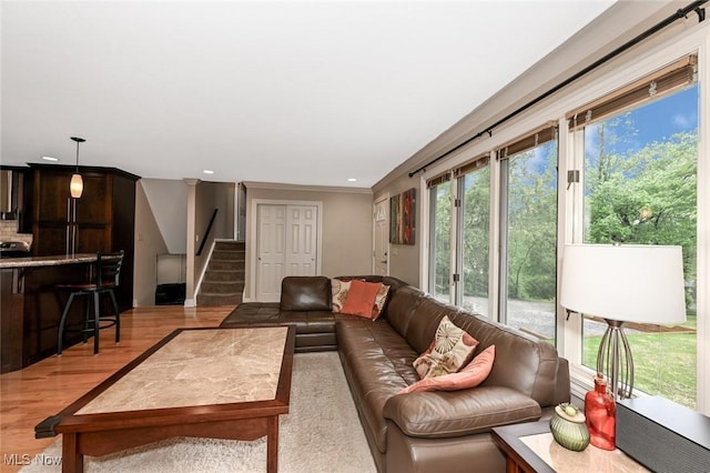 3576 Ellen Dr, Akron, OH 44312 - living area with wood finished floors, stairs, recessed lighting, and crown molding