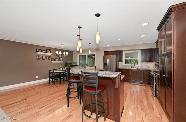 3576 Ellen Dr, Akron, OH 44312 - kitchen with stainless steel fridge with ice dispenser, gas range oven, light wood-style floors, decorative backsplash, and ornamental molding