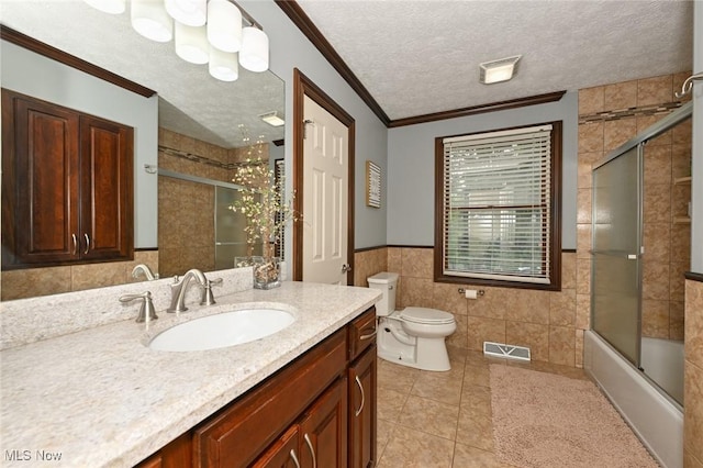 3576 Ellen Dr, Akron, OH 44312 - bathroom with tile walls, tile patterned flooring, toilet, vanity, and a textured ceiling