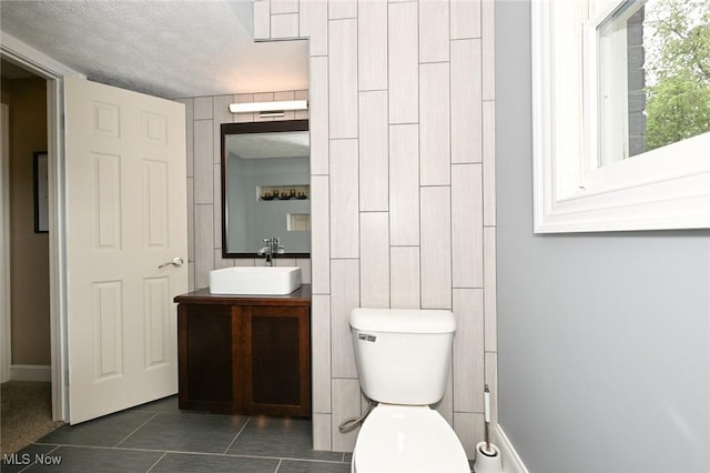 3576 Ellen Dr, Akron, OH 44312 - bathroom featuring vanity, toilet, tile patterned floors, a textured ceiling, and baseboards