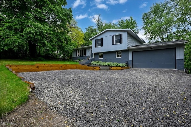 3576 Ellen Dr, Akron, OH 44312 - tri-level home with an attached garage, driveway, and brick siding