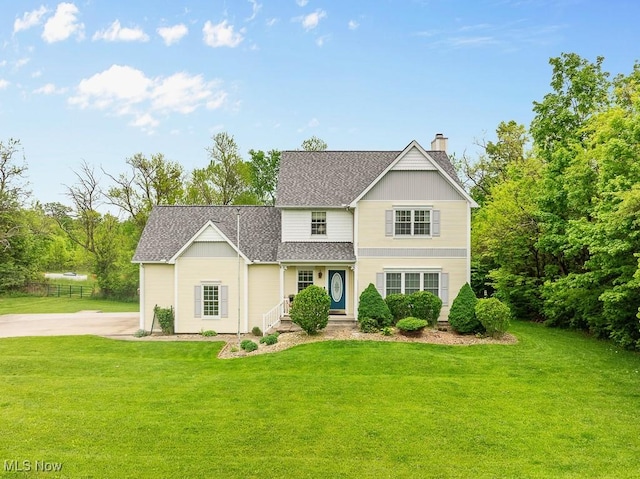5215 Kapok Dr, Medina, OH 44256 - traditional-style home with a shingled roof, a chimney, and a front yard