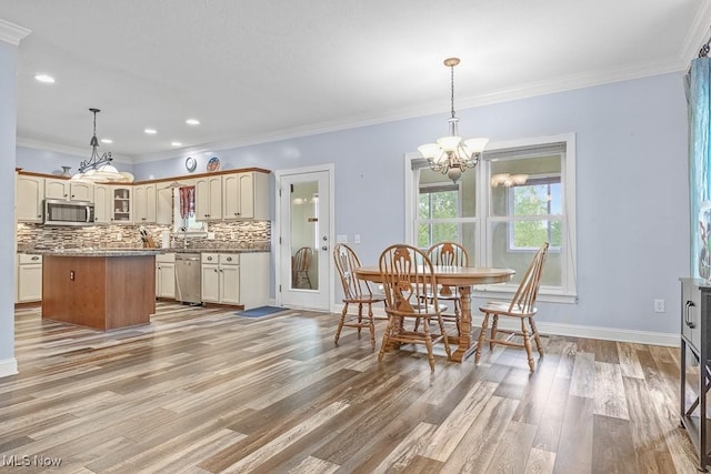 5215 Kapok Dr, Medina, OH 44256 - dining space with a chandelier, light wood finished floors, baseboards, ornamental molding, and recessed lighting