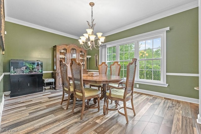 5215 Kapok Dr, Medina, OH 44256 - dining room with wood finished floors, a chandelier, ornamental molding, and baseboards