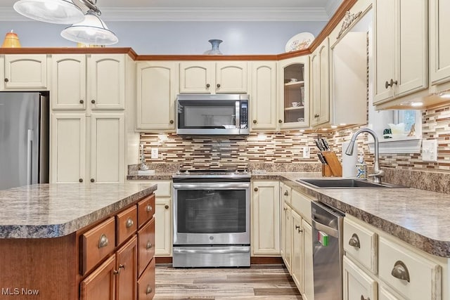 5215 Kapok Dr, Medina, OH 44256 - kitchen featuring appliances with stainless steel finishes, a sink, decorative backsplash, wood finished floors, and glass insert cabinets