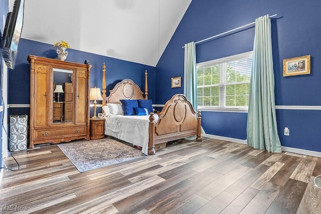 5215 Kapok Dr, Medina, OH 44256 - bedroom with vaulted ceiling, wood finished floors, and baseboards