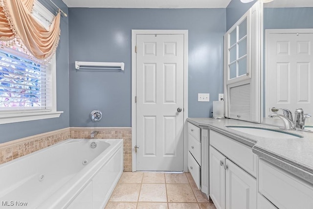 5215 Kapok Dr, Medina, OH 44256 - bathroom with vanity, a tub with jets, tile walls, wainscoting, and tile patterned flooring