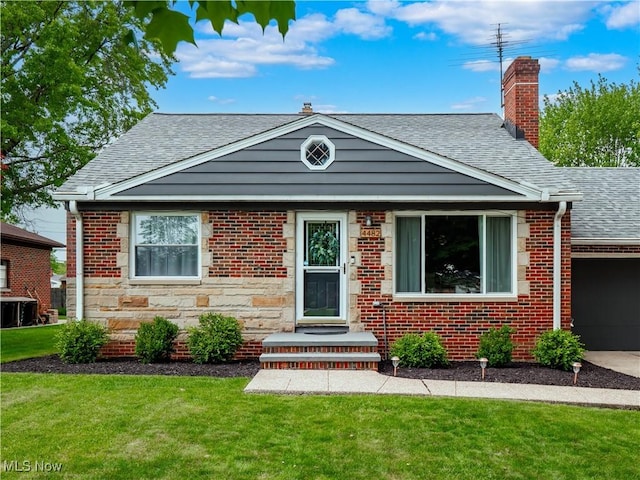 4482 Ranchview Ave, North Olmsted, OH 44070 - bungalow-style house with a shingled roof, a front lawn, an attached garage, central AC unit, and a chimney