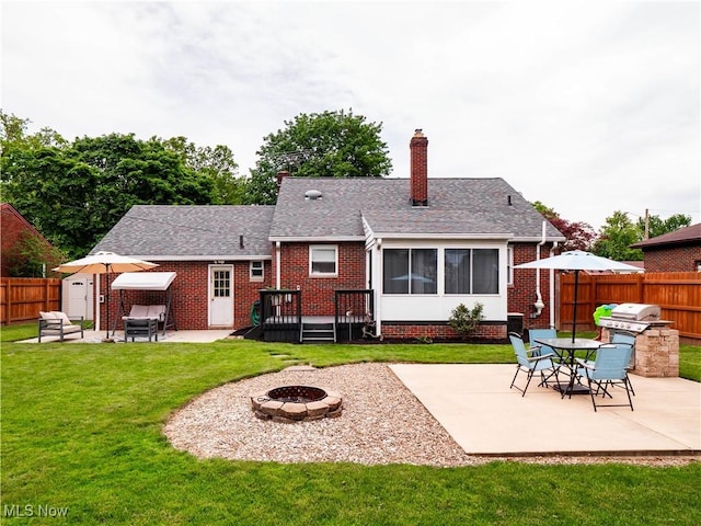 4482 Ranchview Ave, North Olmsted, OH 44070 - back of property featuring a fire pit, a patio, brick siding, a chimney, and roof with shingles