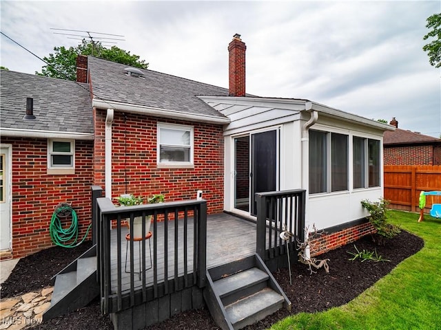 4482 Ranchview Ave, North Olmsted, OH 44070 - rear view of property featuring a chimney, a deck, brick siding, and a sunroom