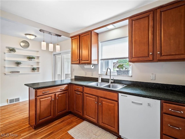 4482 Ranchview Ave, North Olmsted, OH 44070 - kitchen featuring dishwasher, a sink, a peninsula, dark countertops, and wood finished floors