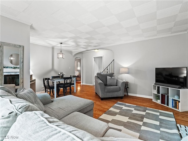 4482 Ranchview Ave, North Olmsted, OH 44070 - living room with arched walkways, stairs, crown molding, wood finished floors, and baseboards