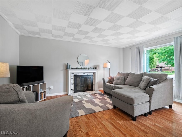 4482 Ranchview Ave, North Olmsted, OH 44070 - living area with wood finished floors, ornamental molding, a glass covered fireplace, and baseboards