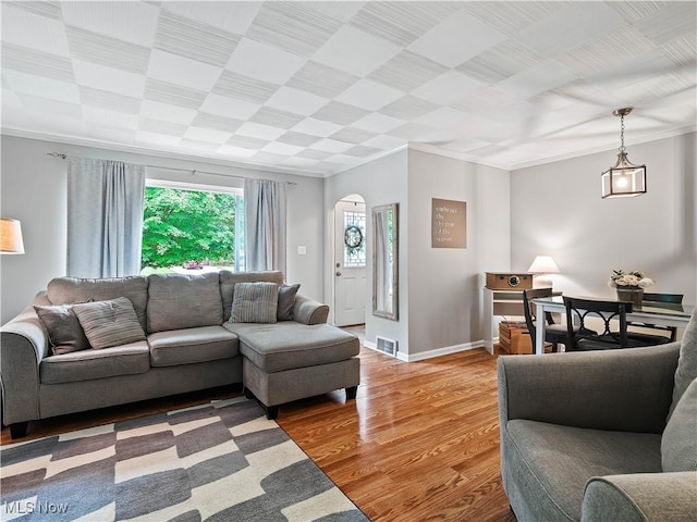 4482 Ranchview Ave, North Olmsted, OH 44070 - living area with crown molding, light wood-style flooring, baseboards, and arched walkways