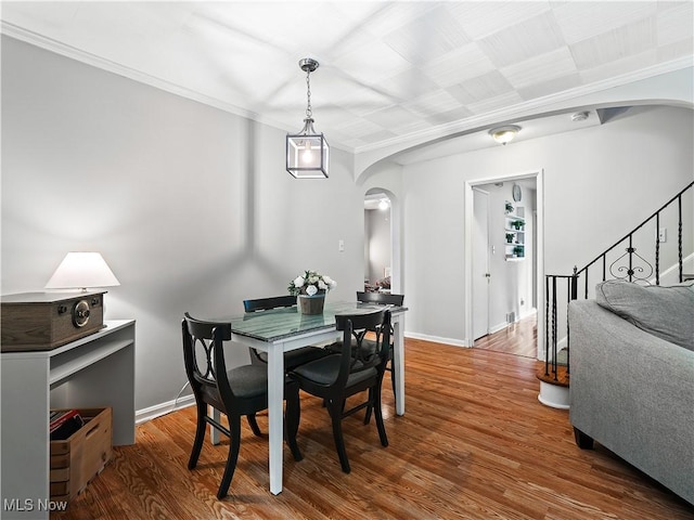 4482 Ranchview Ave, North Olmsted, OH 44070 - dining space with arched walkways, wood finished floors, baseboards, crown molding, and stairs