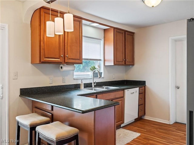 4482 Ranchview Ave, North Olmsted, OH 44070 - kitchen featuring a sink, white dishwasher, dark countertops, and brown cabinets