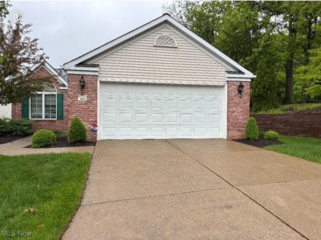 14250 Reserve Ln, Middleburg Heights, OH 44130 - view of front facade with brick siding, concrete driveway, and a garage
