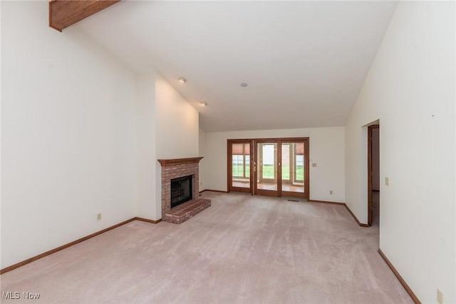 14250 Reserve Ln, Middleburg Heights, OH 44130 - unfurnished living room featuring light colored carpet, a fireplace, baseboards, high vaulted ceiling, and french doors