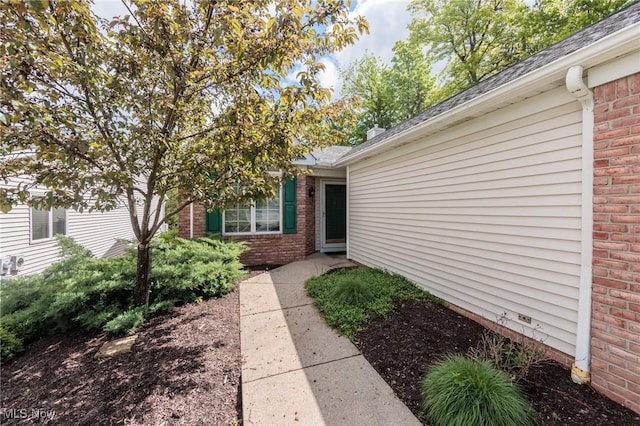 14250 Reserve Ln, Middleburg Heights, OH 44130 - view of exterior entry with a shingled roof and brick siding