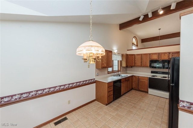 14250 Reserve Ln, Middleburg Heights, OH 44130 - kitchen with black appliances, brown cabinetry, rail lighting, decorative light fixtures, and light countertops
