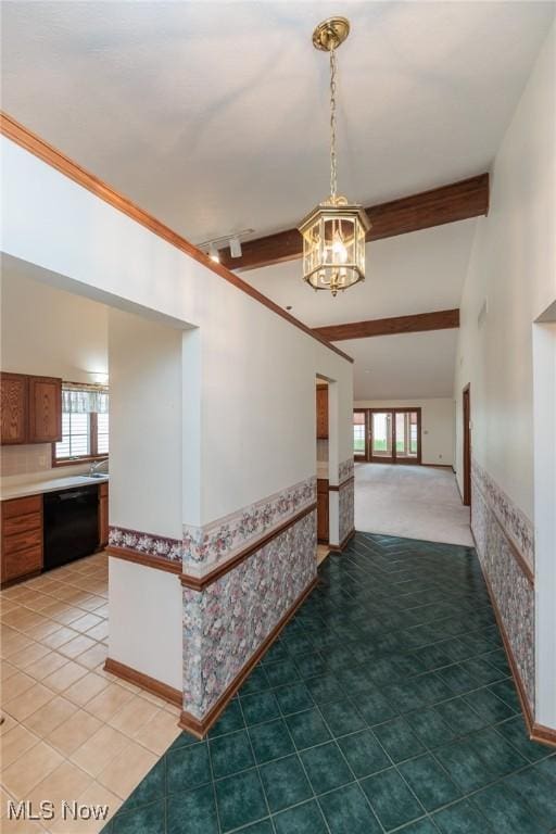 14250 Reserve Ln, Middleburg Heights, OH 44130 - hall featuring a chandelier, healthy amount of natural light, beam ceiling, baseboards, and a sink