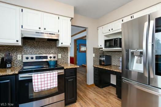1339 Harmony Dr, Wadsworth, OH 44281 - kitchen with stainless steel appliances, under cabinet range hood, light wood-style floors, and white cabinetry