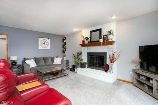 1339 Harmony Dr, Wadsworth, OH 44281 - living room featuring carpet flooring, a glass covered fireplace, and baseboards