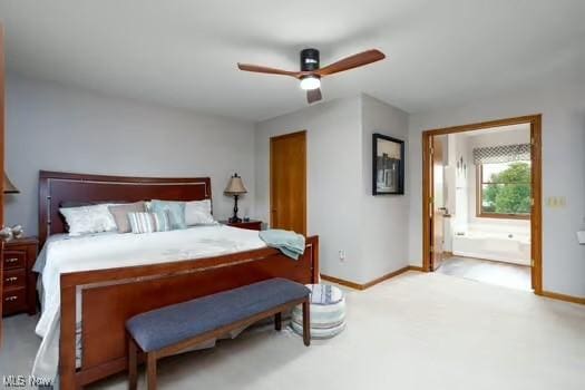 1339 Harmony Dr, Wadsworth, OH 44281 - carpeted bedroom featuring baseboards, connected bathroom, and a ceiling fan