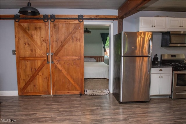 625 Bristol Champion Townline Rd NW, Bristolville, OH 44402 - kitchen with appliances with stainless steel finishes, dark wood-style floors, white cabinets, and a barn door