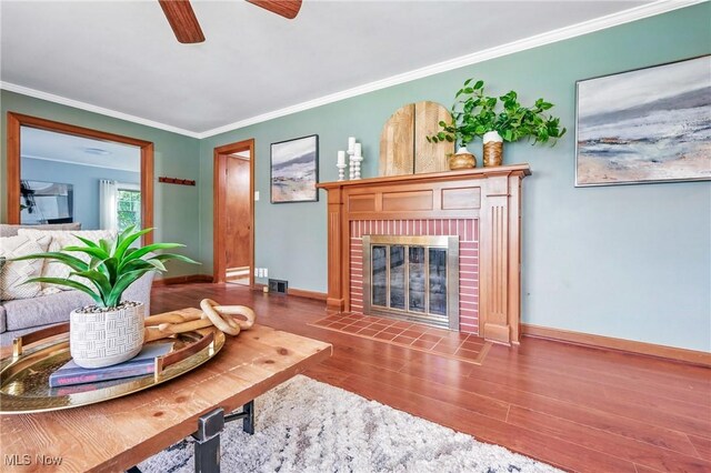 298 W Chestnut St, Lisbon, OH 44432 - living room with wood finished floors, baseboards, ceiling fan, ornamental molding, and a fireplace
