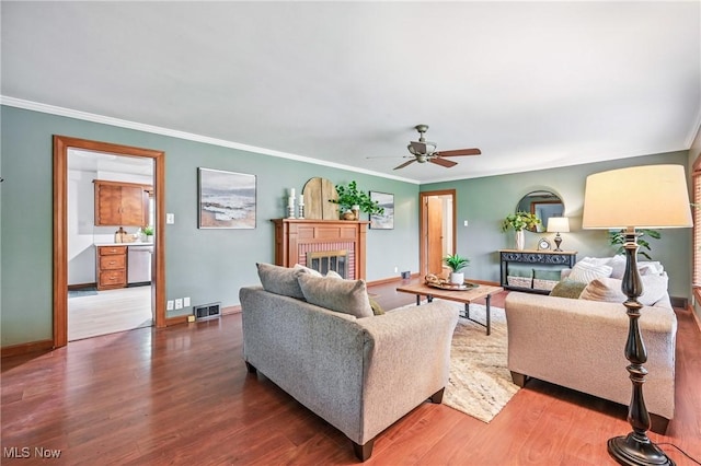 298 W Chestnut St, Lisbon, OH 44432 - living area featuring wood finished floors, a brick fireplace, ceiling fan, crown molding, and baseboards
