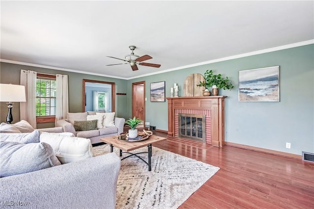 298 W Chestnut St, Lisbon, OH 44432 - living area featuring ornamental molding, wood finished floors, baseboards, ceiling fan, and a fireplace
