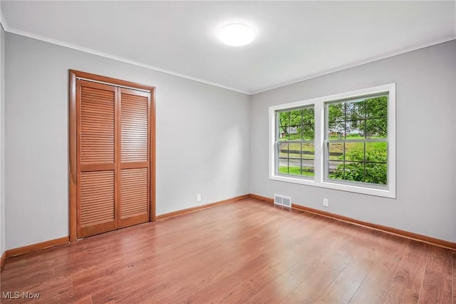298 W Chestnut St, Lisbon, OH 44432 - unfurnished bedroom with ornamental molding, baseboards, wood finished floors, and a closet